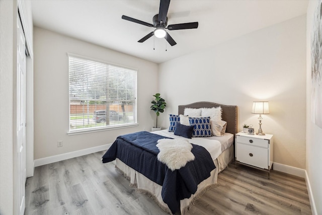13411 Via Chianti Ln, Cypress, TX 77429 - bedroom featuring light wood finished floors and a ceiling fan