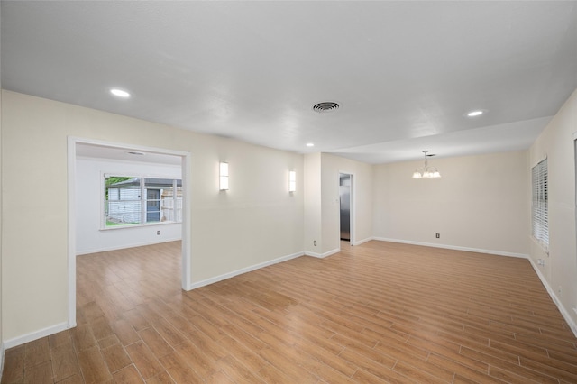 3835 Tartan Ln, Houston, TX 77025 - empty room with a chandelier, light wood-style flooring, and recessed lighting