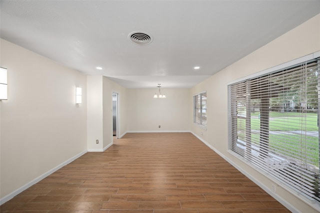 3835 Tartan Ln, Houston, TX 77025 - unfurnished room with a chandelier, recessed lighting, and wood finished floors