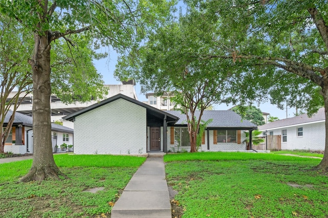 3835 Tartan Ln, Houston, TX 77025 - view of front of house with a front lawn and brick siding