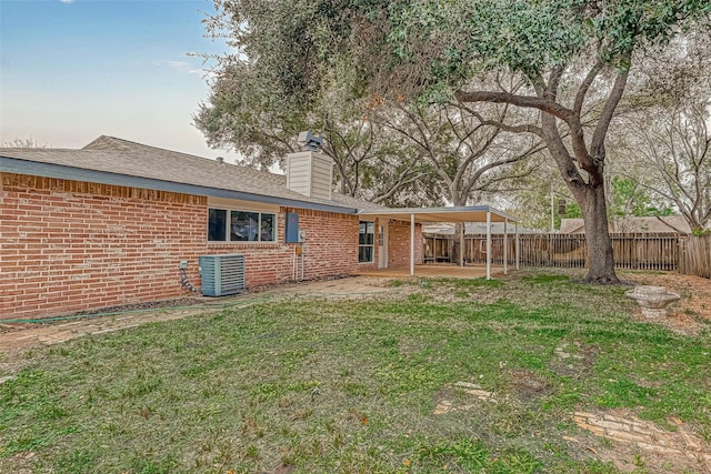 2330 Grindstone Ln, Sugar Land, TX 77498 - back of property featuring brick siding, a fenced backyard, a patio, a chimney, and roof with shingles