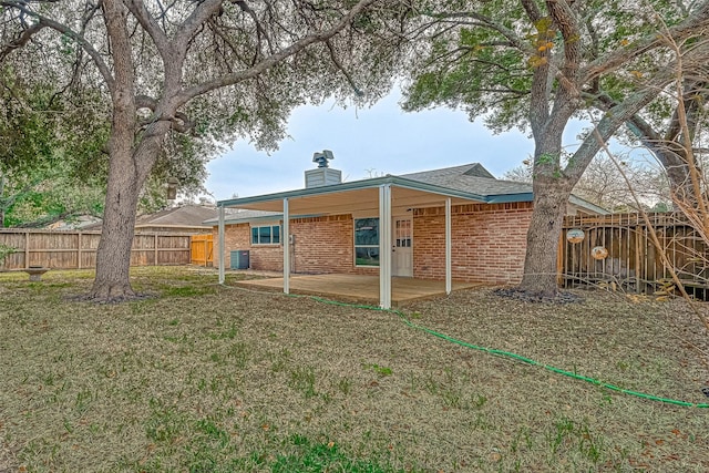 2330 Grindstone Ln, Sugar Land, TX 77498 - rear view of property with a chimney, a patio, brick siding, and a fenced backyard