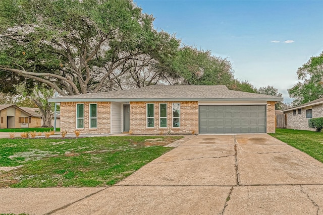 2330 Grindstone Ln, Sugar Land, TX 77498 - ranch-style house featuring brick siding, an attached garage, a front yard, and driveway