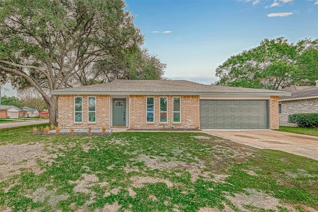 2330 Grindstone Ln, Sugar Land, TX 77498 - ranch-style house featuring an attached garage, driveway, brick siding, and a front lawn
