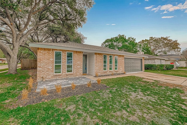 2330 Grindstone Ln, Sugar Land, TX 77498 - view of front of property with an attached garage, driveway, brick siding, and a front lawn