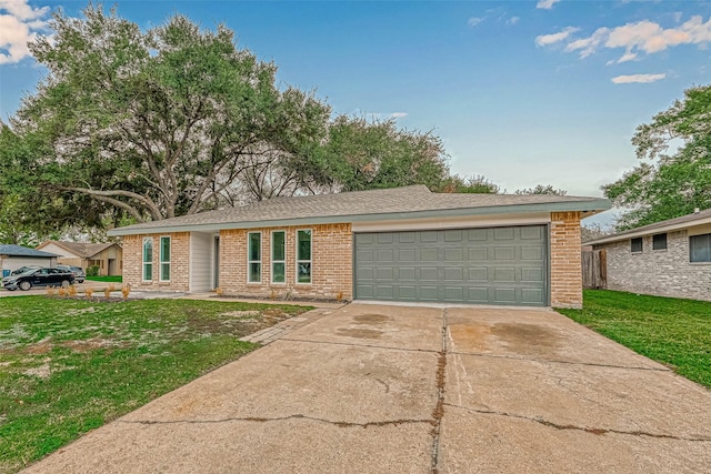 2330 Grindstone Ln, Sugar Land, TX 77498 - ranch-style home with brick siding, concrete driveway, an attached garage, and a front lawn