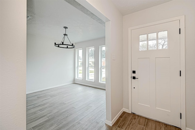 2330 Grindstone Ln, Sugar Land, TX 77498 - foyer featuring a chandelier and wood finished floors