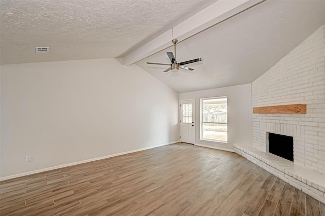2330 Grindstone Ln, Sugar Land, TX 77498 - unfurnished living room with wood finished floors, ceiling fan, a fireplace, and a textured ceiling