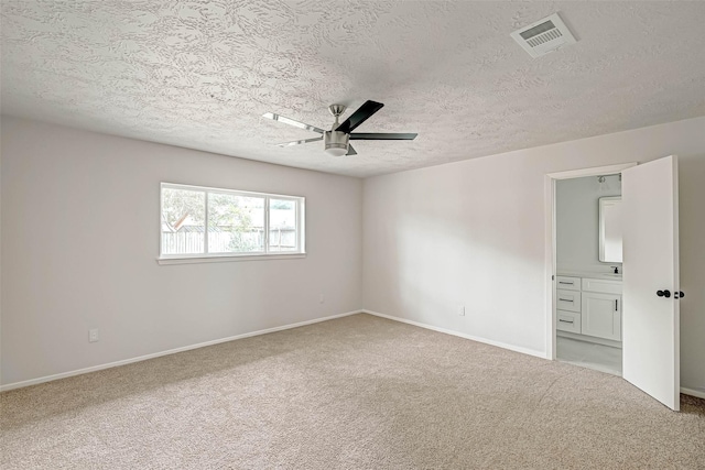2330 Grindstone Ln, Sugar Land, TX 77498 - unfurnished bedroom with light carpet, a textured ceiling, connected bathroom, and a ceiling fan