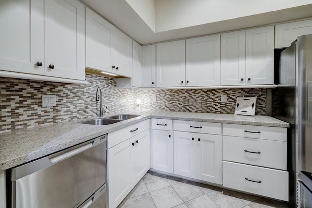 1330 Augusta Dr Unit 6, Houston, TX 77057 - kitchen with stainless steel appliances, light tile patterned flooring, white cabinets, and backsplash