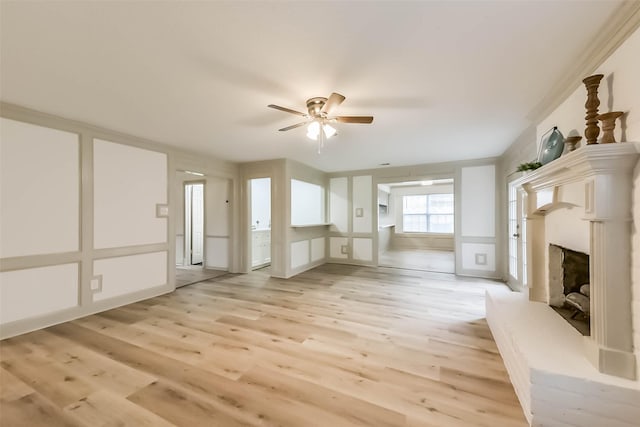 4214 Brightwood Dr, Houston, TX 77068 - unfurnished living room featuring ceiling fan, a fireplace with raised hearth, light wood-style floors, and a decorative wall