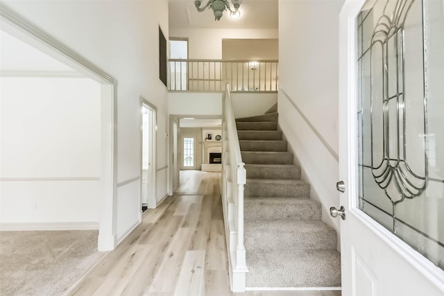 4214 Brightwood Dr, Houston, TX 77068 - entrance foyer with stairway, light wood finished floors, and a fireplace with raised hearth