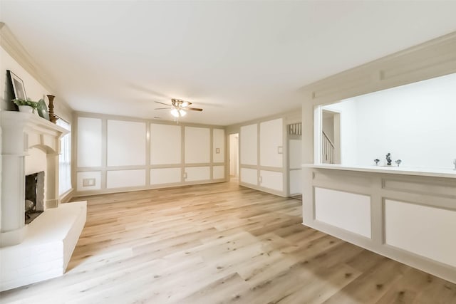 4214 Brightwood Dr, Houston, TX 77068 - unfurnished living room featuring light wood finished floors, ceiling fan, and a fireplace with raised hearth