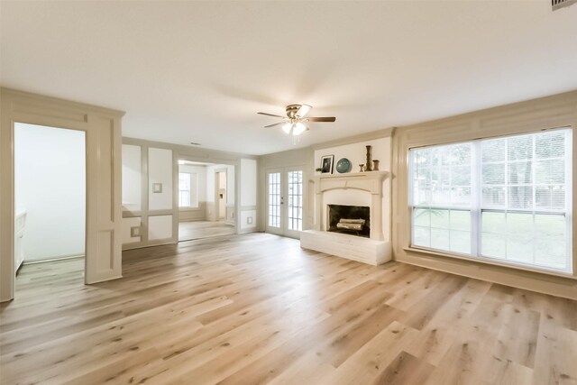 4214 Brightwood Dr, Houston, TX 77068 - unfurnished living room with ceiling fan, light wood-style floors, and a fireplace with raised hearth