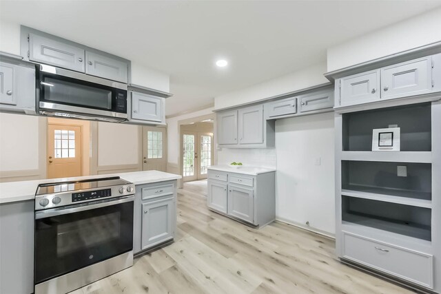 4214 Brightwood Dr, Houston, TX 77068 - kitchen with gray cabinets, stainless steel appliances, light wood finished floors, french doors, and light countertops