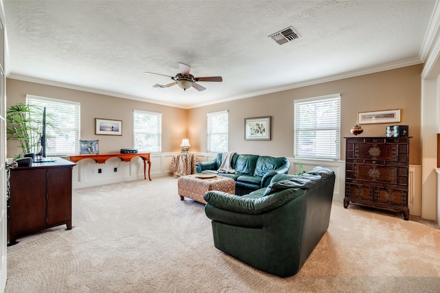 510 Commodore Way, Houston, TX 77079 - carpeted living area featuring ornamental molding, a ceiling fan, healthy amount of natural light, a wainscoted wall, and a textured ceiling