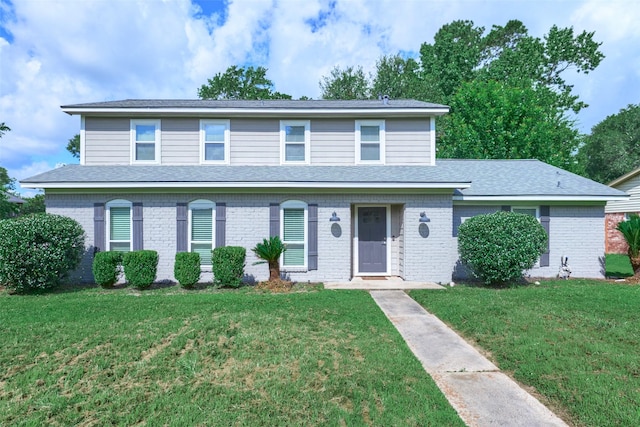 725 River Plantation Dr, Conroe, TX 77302 - view of front of house featuring a front yard and brick siding