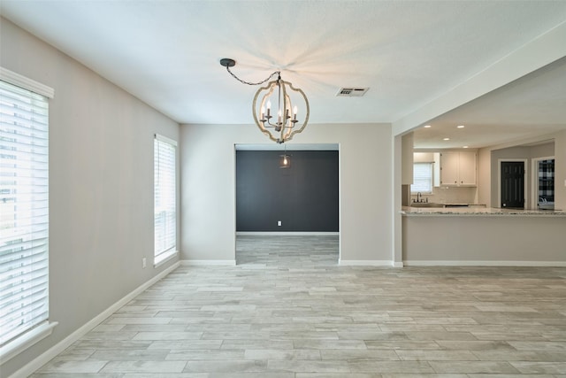 725 River Plantation Dr, Conroe, TX 77302 - spare room featuring light wood-style flooring, a chandelier, and recessed lighting