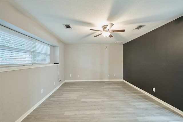 725 River Plantation Dr, Conroe, TX 77302 - spare room with a ceiling fan, light wood-type flooring, and a textured ceiling