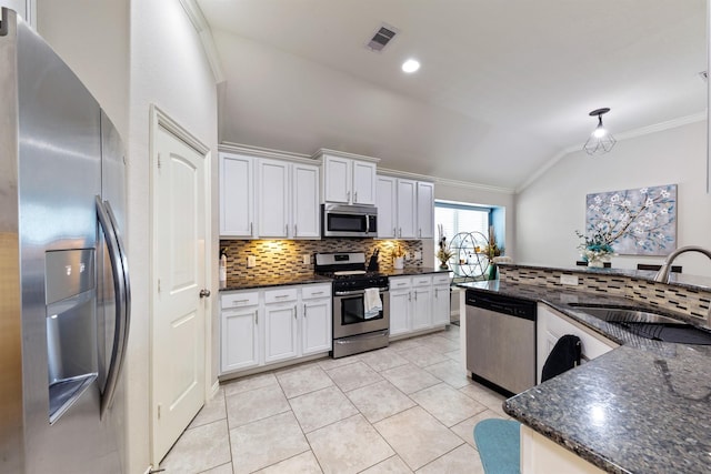 3515 Cactus Field Ln, Katy, TX 77449 - kitchen featuring stainless steel appliances, lofted ceiling, ornamental molding, tasteful backsplash, and light tile patterned flooring