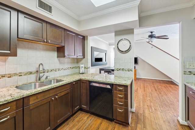 5082 Augusta St, Houston, TX 77007 - kitchen with black dishwasher, light wood-type flooring, ceiling fan, backsplash, and light stone countertops