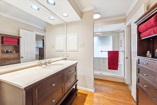 5082 Augusta St, Houston, TX 77007 - bathroom featuring ornamental molding, vanity, wood finished floors, a stall shower, and recessed lighting
