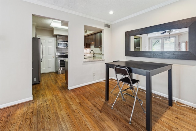 5082 Augusta St, Houston, TX 77007 - dining area with dark wood-style flooring, crown molding, recessed lighting, and ceiling fan