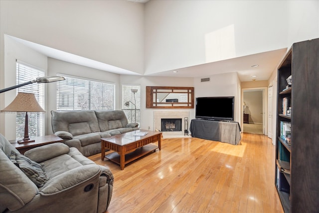 5082 Augusta St, Houston, TX 77007 - living room with a towering ceiling, light wood-style flooring, and a fireplace