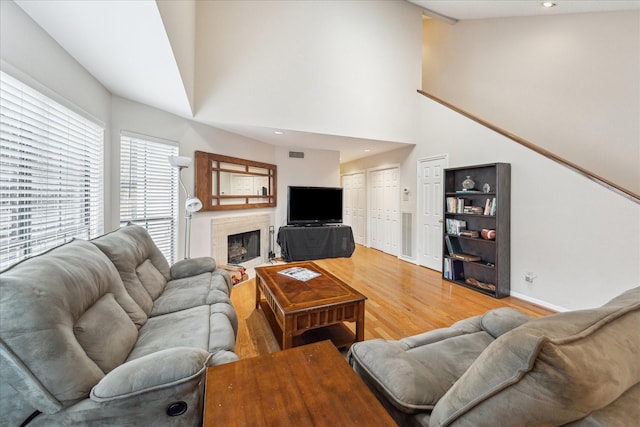 5082 Augusta St, Houston, TX 77007 - living room with lofted ceiling, light wood-style flooring, a premium fireplace, and recessed lighting