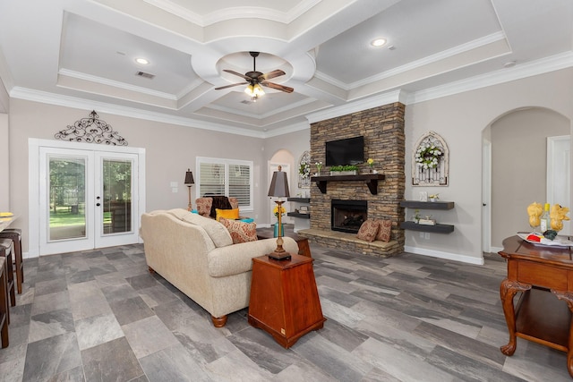 27724 Colapis Dr, Splendora, TX 77372 - living room featuring a ceiling fan, arched walkways, a fireplace, coffered ceiling, and french doors