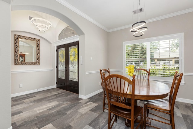 27724 Colapis Dr, Splendora, TX 77372 - dining area featuring french doors, arched walkways, a chandelier, and crown molding