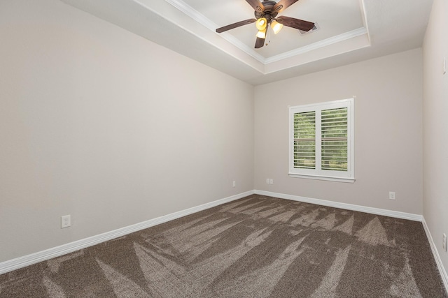 27724 Colapis Dr, Splendora, TX 77372 - spare room with dark colored carpet, a ceiling fan, ornamental molding, and a tray ceiling