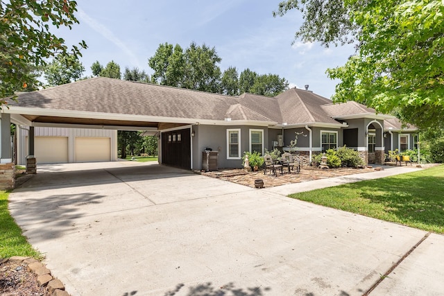 27724 Colapis Dr, Splendora, TX 77372 - view of front of home with a garage, driveway, stucco siding, and a shingled roof