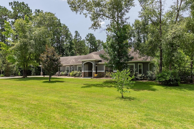 27724 Colapis Dr, Splendora, TX 77372 - ranch-style home featuring a front yard, stone siding, and stucco siding