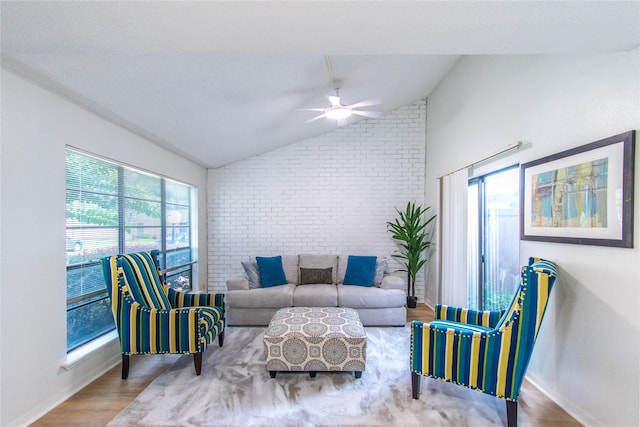 2429 Briarwest Blvd, Houston, TX 77077 - living room with vaulted ceiling, a ceiling fan, wood finished floors, and brick wall