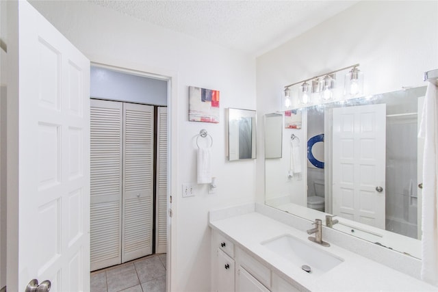 2429 Briarwest Blvd, Houston, TX 77077 - bathroom with a closet, vanity, tile patterned floors, and a textured ceiling