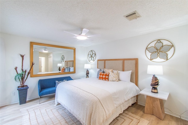 2429 Briarwest Blvd, Houston, TX 77077 - bedroom with a textured ceiling, wood finished floors, and a ceiling fan