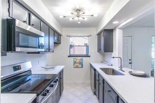 2429 Briarwest Blvd, Houston, TX 77077 - kitchen with appliances with stainless steel finishes, a chandelier, light countertops, and light tile patterned floors