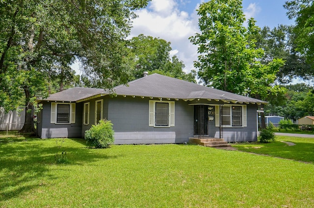 1700 Marilyn St, Rosenberg, TX 77471 - view of front facade with a front yard and a shingled roof