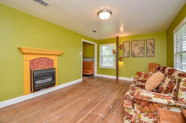 1700 Marilyn St, Rosenberg, TX 77471 - living room with wood-type flooring, a tile fireplace, and healthy amount of natural light