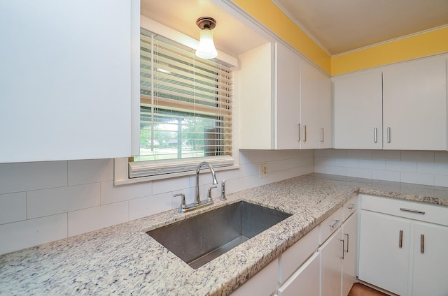 1700 Marilyn St, Rosenberg, TX 77471 - kitchen featuring tasteful backsplash, white cabinetry, light stone countertops, and ornamental molding