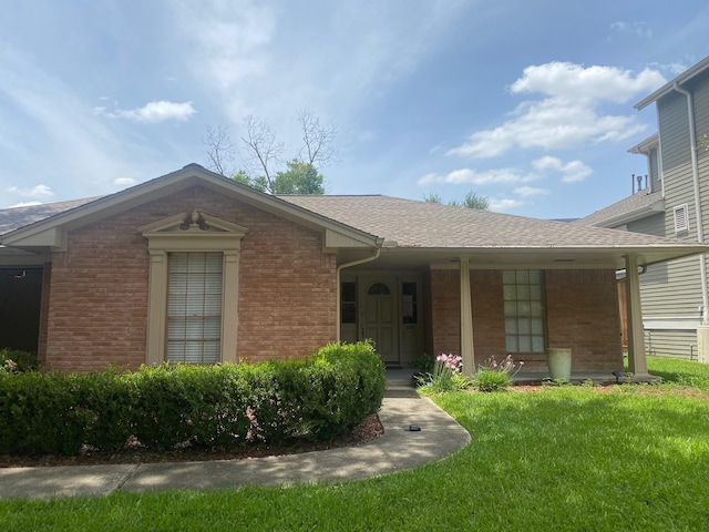 6220 Queenswood Ln, Houston, TX 77008 - view of front of house featuring covered porch, brick siding, a front yard, and a shingled roof