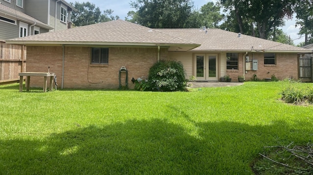 6220 Queenswood Ln, Houston, TX 77008 - back of house featuring french doors, a shingled roof, and brick siding