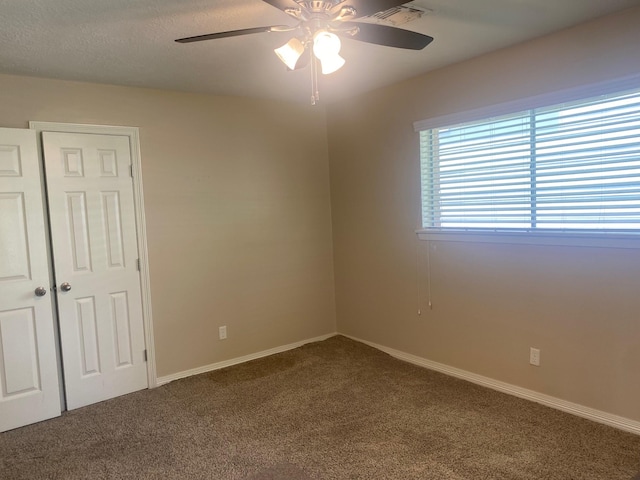 6220 Queenswood Ln, Houston, TX 77008 - unfurnished room with dark colored carpet and ceiling fan