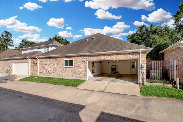 5022 Coral Gables Dr, Houston, TX 77069 - view of front of property featuring a shingled roof, an attached garage, driveway, and brick siding