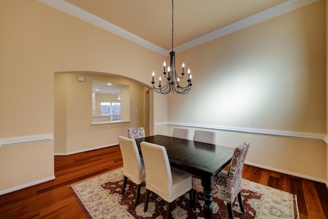 5022 Coral Gables Dr, Houston, TX 77069 - dining room with arched walkways, a chandelier, ornamental molding, and wood finished floors
