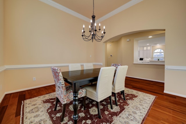 5022 Coral Gables Dr, Houston, TX 77069 - dining area with arched walkways, crown molding, a chandelier, and wood finished floors