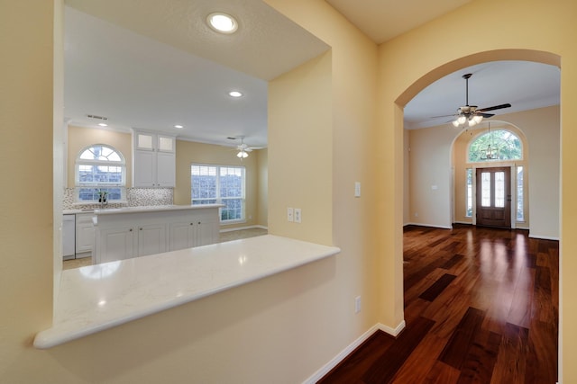 5022 Coral Gables Dr, Houston, TX 77069 - entrance foyer with arched walkways, a ceiling fan, dark wood-style floors, plenty of natural light, and recessed lighting