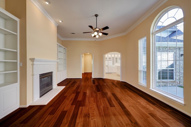 5022 Coral Gables Dr, Houston, TX 77069 - unfurnished living room with arched walkways, wood finished floors, ornamental molding, a ceiling fan, and healthy amount of natural light