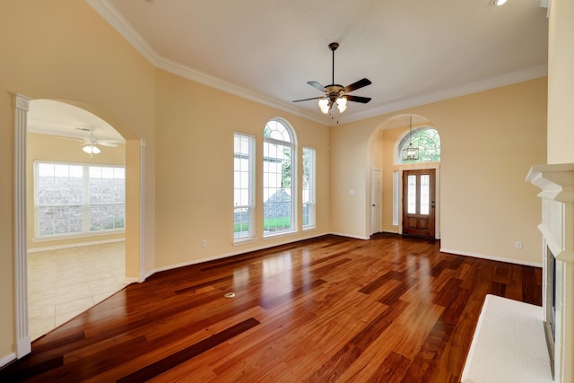 5022 Coral Gables Dr, Houston, TX 77069 - foyer entrance with arched walkways, a ceiling fan, wood finished floors, and ornamental molding